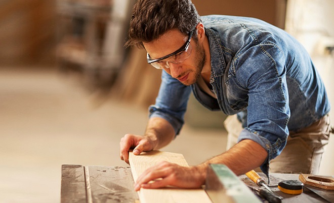 carpenter working with a plank of wood