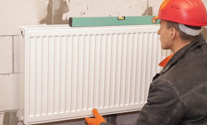engineer installing a radiator
