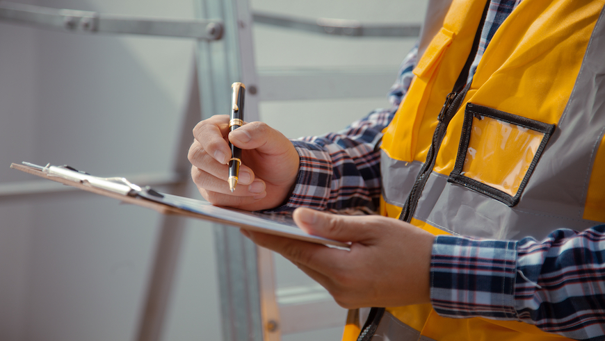 person checking a clipboard